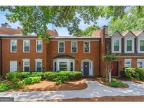 Charming brick townhome featuring mature trees and landscaping, creating a welcoming curb appeal at 4113 Ashford Green Dr, Duluth, GA 30096