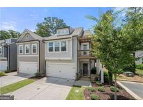 Charming two-story townhome featuring an attached garage and a quaint second story balcony at 774 Belrose Dr, Smyrna, GA 30080