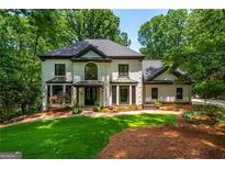 Stately two-story home with a manicured lawn and mature trees at 210 Hunters Vw, Roswell, GA 30075