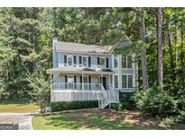 Charming two-story home with a welcoming front porch and lush landscaping at 3 Maplelake Dr, Acworth, GA 30101