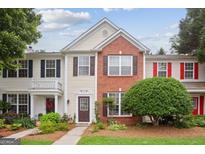 Charming two-story townhouse with a brick facade and well-manicured landscaping at 1911 Stancrest Nw Trce, Kennesaw, GA 30152