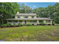 Charming two-story home with inviting front porch and beautifully landscaped front yard at 2110 Waterloo Cir, Lawrenceville, GA 30043