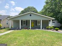 Charming single-story home features a well-maintained lawn and a welcoming front porch with columns at 644 Albert Nw St, Atlanta, GA 30318