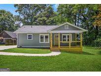 Charming cottage-style home with a welcoming front porch and well-maintained lawn at 1675 White Oak Way, Decatur, GA 30032