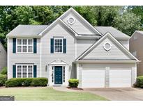 Charming two-story home with a well-manicured lawn, blue shutters, and an attached two-car garage at 2821 Amhurst Nw Way, Kennesaw, GA 30144
