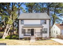 Charming two-story home with a welcoming front porch and well-maintained landscaping at 870 Gaston Sw St, Atlanta, GA 30310