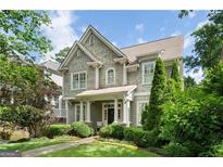 Charming two-story home with gray wood shingle siding, manicured landscaping and inviting front porch at 785 Wilson Nw Rd, Atlanta, GA 30318