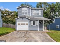 Charming two-story home featuring a covered porch, attached garage, and concrete driveway at 4706 Cedar Park Trl, Stone Mountain, GA 30083