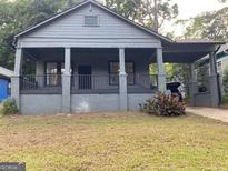 Charming bungalow style house featuring a covered front porch and a gray painted exterior at 1053 Metropolitan Parkway Southwest Sw Pkwy, Atlanta, GA 30310