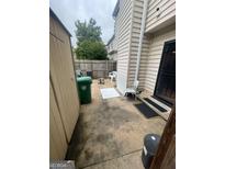 The backyard patio area features a shed, chairs, and a view of the wooden fence and partial house exterior at 2009 Oak Park Ln, Decatur, GA 30032