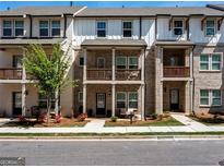 Charming two-story brick townhome with inviting balconies and well-manicured landscaping at 4065 Holland Grove, Lawrenceville, GA 30044