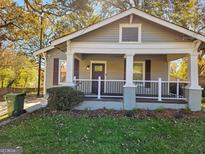 Charming home with a covered front porch, white columns, and a well-maintained lawn in a desirable neighborhood at 2148 M L King Jr Sw Dr, Atlanta, GA 30310