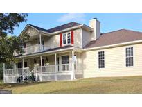 Charming two-story home with a welcoming front porch and a second-story balcony at 4335 Commodore Rd, Powder Springs, GA 30127