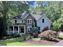 Charming two-story home with stone accents, a welcoming front porch, and beautiful landscaping at 1788 River Bluff Vw, Duluth, GA 30097