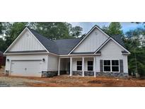 Charming, craftsman-style home featuring white siding, stone accents, and a welcoming front porch at 5502 Lakeview Pkwy, Villa Rica, GA 30180