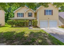 Charming two-story home with a two-car garage and a well-maintained, verdant front yard at 260 Redding Rdg, Atlanta, GA 30349