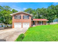 Charming two-story brick home with a well-manicured lawn and a two-car garage at 2117 Chestnut Hill Circle Cir, Decatur, GA 30032
