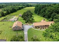 Stunning aerial view of country estate with lush green fields, brick homes and serene landscape at 1502 Campground, Mcdonough, GA 30252