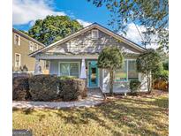 Charming bungalow-style home with a tidy front yard, updated paint, and a pop of color on the front door at 1283 Mercer, East Point, GA 30344