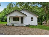 Charming single-story home featuring a welcoming porch and a freshly painted exterior at 4451 Flat Shoals, Decatur, GA 30034