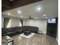 Spacious living room features hardwood floors, recessed lighting, and a modern ceiling fan at 176 Avalon Way, Riverdale, GA 30274