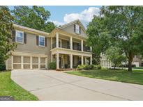 Charming two-story home features a welcoming front porch and attached two-car garage at 826 Richmond Cir, Peachtree City, GA 30269