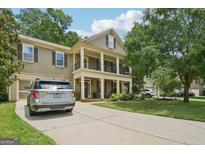 Inviting two-story home with a welcoming front porch and well-maintained landscaping, plus a two car garage at 826 Richmond Cir, Peachtree City, GA 30269