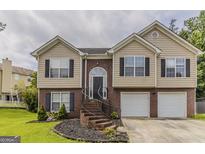 Charming two-story home featuring brick and siding exterior with a well-manicured front yard at 1006 Eagle Vw, Lawrenceville, GA 30044