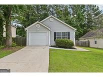 Charming single Gathering home with a well-maintained lawn and attached garage at 1528 Wembley Dr, Douglasville, GA 30134
