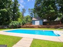 Inviting in-ground pool, perfect for relaxing or entertaining in a private backyard setting at 2913 Jordan Forest Trail, Lawrenceville, GA 30044