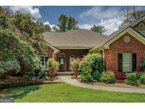 Charming brick home featuring well-manicured landscaping and an inviting front entrance at 1041 Flat Rock Rd, Covington, GA 30014