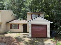 Charming home featuring a one-car garage, with neutral siding and red trim at 101 Pinetree Trl, Atlanta, GA 30349