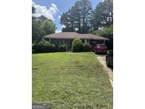 Cozy single-story brick home with a well-maintained lawn, mature landscaping, and a convenient driveway at 2941 Gresham Se Rd, Atlanta, GA 30316