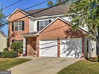 Charming two-story brick home with a two-car garage and well-maintained landscaping at 1399 Cutters Mill Dr, Lithonia, GA 30058