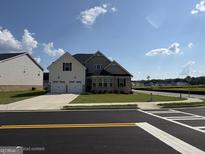 Charming two-story home with a two-car garage and well-maintained front yard, offering great curb appeal at 13709 Whitman Ln, Covington, GA 30014