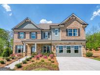 Charming two-story home with brick and siding exterior, landscaped yard, and inviting front porch at 313 Westfall Ter # 225A, Loganville, GA 30052