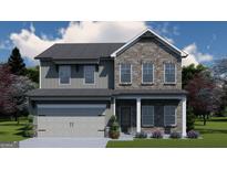 Charming two-story home with brick and gray siding, featuring a two-car garage and manicured lawn at 504 Clayborne Way # 248A, Loganville, GA 30052