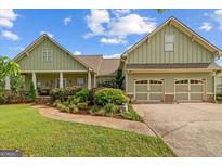 Inviting home with an attached two-car garage and a beautifully landscaped front yard and walkway at 9360 Ward Rd, Winston, GA 30187