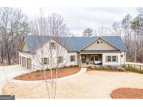 Charming single-Gathering home featuring a landscaped yard, attached garage, and inviting front porch perfect for relaxing at 150 Seals Rd, Dallas, GA 30157