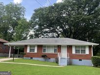 Charming brick home with a well-maintained front yard and welcoming entrance at 24 Mobley Se Dr, Atlanta, GA 30315