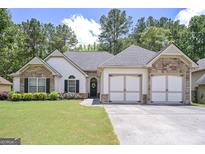 Charming home featuring a well-manicured lawn, stone accents, and a two-car garage at 170 Saddleridge Dr, Bremen, GA 30110