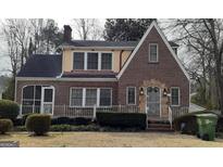 Charming brick Tudor-style home with manicured landscaping and a cozy, inviting entrance at 1270 M L King Jr Sw Dr, Atlanta, GA 30314