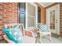 Inviting front porch with stylish outdoor seating and charming decor that adds a touch of elegance at 3502 Village Green Dr, Roswell, GA 30075