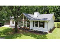 Charming home featuring stone accents, fresh landscaping, and a neatly maintained lawn at 125 Selena Ct, Fayetteville, GA 30215