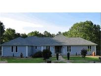 Inviting single story home with a charming walkway and beautiful front yard landscaping at 1455 River Cove Rd, Social Circle, GA 30025
