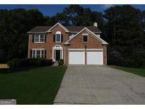Beautiful two-story brick home with a two-car garage and a well-manicured lawn at 7505 Brookwood Way, Cumming, GA 30041