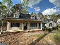 Charming home featuring a welcoming front porch, well-maintained lawn, and attractive curb appeal at 110 Riley Ave, Fayetteville, GA 30214