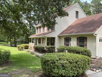 Charming two-story home with a welcoming front porch and well-manicured landscaping at 807 Oak Bridge Ln, Fayetteville, GA 30214