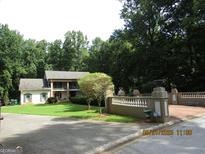 Charming home with a manicured lawn and a stately brick and concrete gated entrance at 5523 Bahia Mar Cir, Stone Mountain, GA 30087
