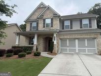 Charming two-story home featuring a brick and siding exterior, complemented by a well-manicured front yard at 2920 Prestwood Dr, Cumming, GA 30040
